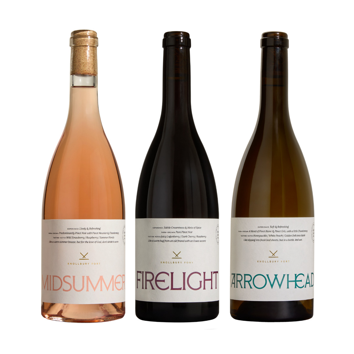 Three wine bottles from Englewood Cellars lined up against a solid white background. The bottles are Midsummer (rose pink), Firelight (very dark red), and Arrowhead (greenish-gray). hide pdp